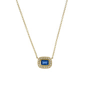 Gold necklace with a blue gemstone pendant on a white background