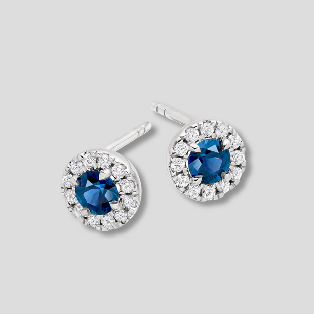 Blue Sapphire And Diamond Halo Stud Earrings In White Gold By FANCI Fine Jewellery, Southampton, UK.
