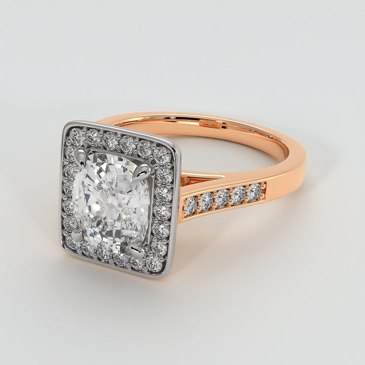 High Halo Engagement Ring With Cushion Cut Centre Diamond Diamond Set Shoulders In Rose Gold. Designed And Manufactured By FANCI Fine Jewellery, Southampton, UK.